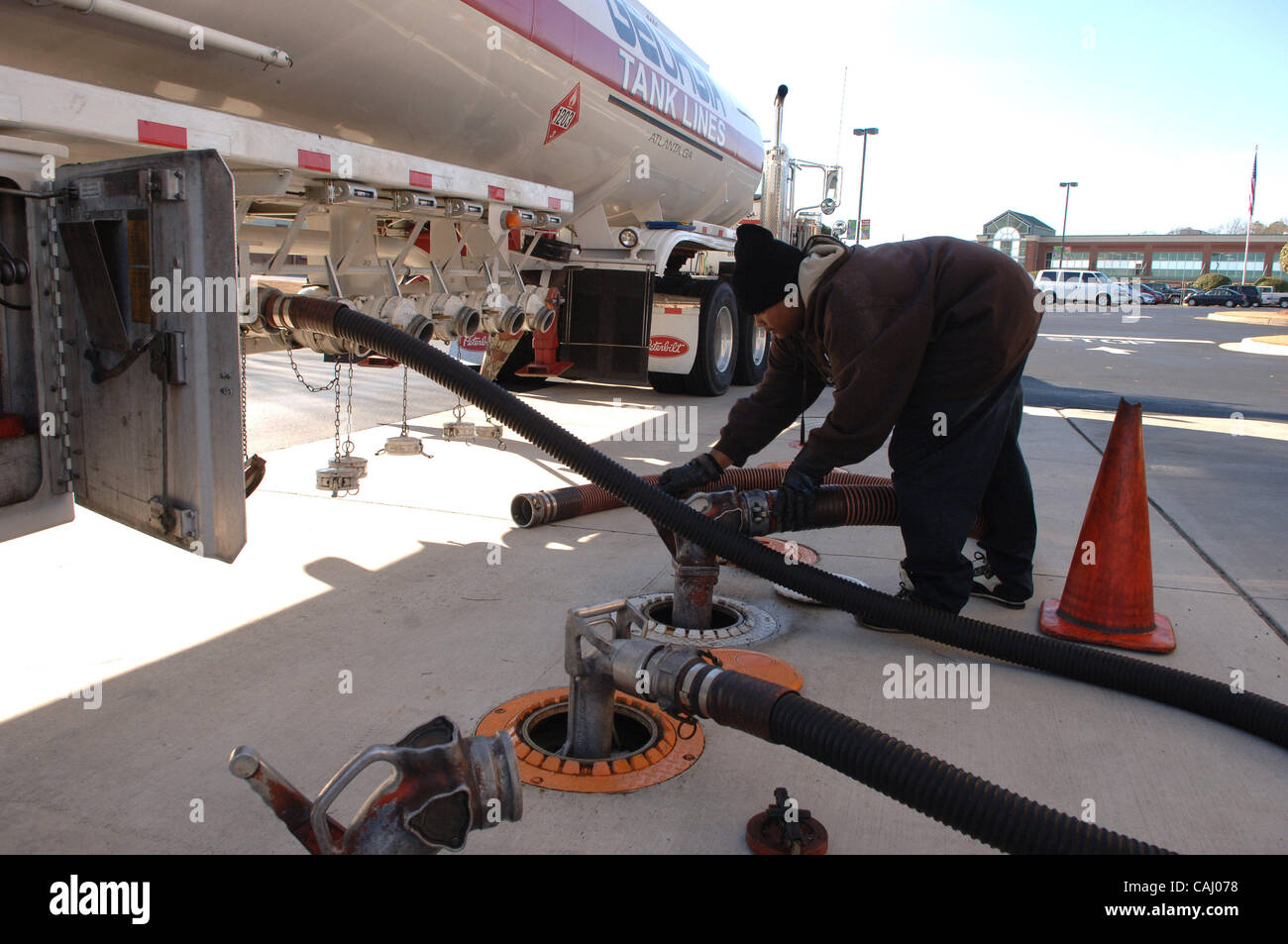 Jerry Howell of Marietta, GA pumps E85 ethanol mix fuel into his 2005