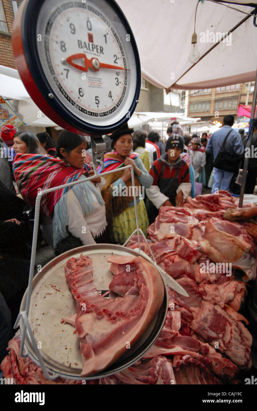 Dec 31, 2007 - La Paz, Bolivia - Pork meat selling in La Paz Garita de Lima's street market.  Every 31st December in La Paz, thousands of dead pigs are brought to the city to be sold, coming from Cochabamba, Santa Cruz and all La Paz areas. The bolivian tradition to eat pork to celebrate the new yea Stock Photo