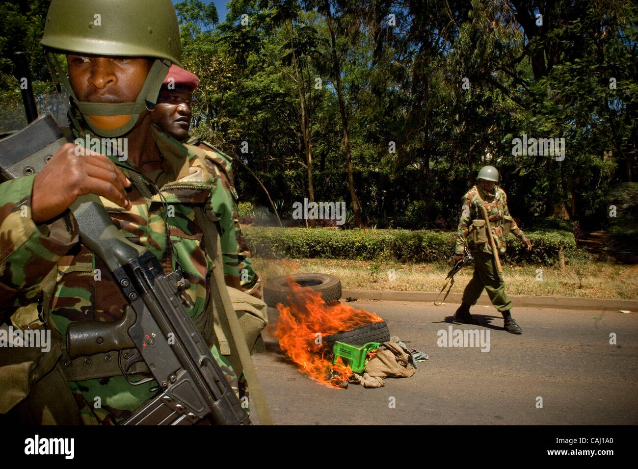 Crude fires and military personnel. On new years eve violence rocked the nations capital, with demonstrators causing Havoc country – wide. With casualties topping 400, the military has been set up around the city to deter the supports of Kenyas opposition movement ODM [ The Orange Democratic Movemen Stock Photo