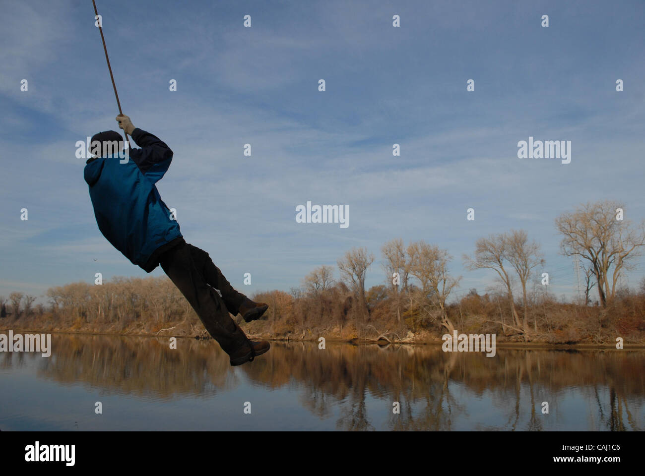 Robert Sewell swings over the American River on a rope swing during a
