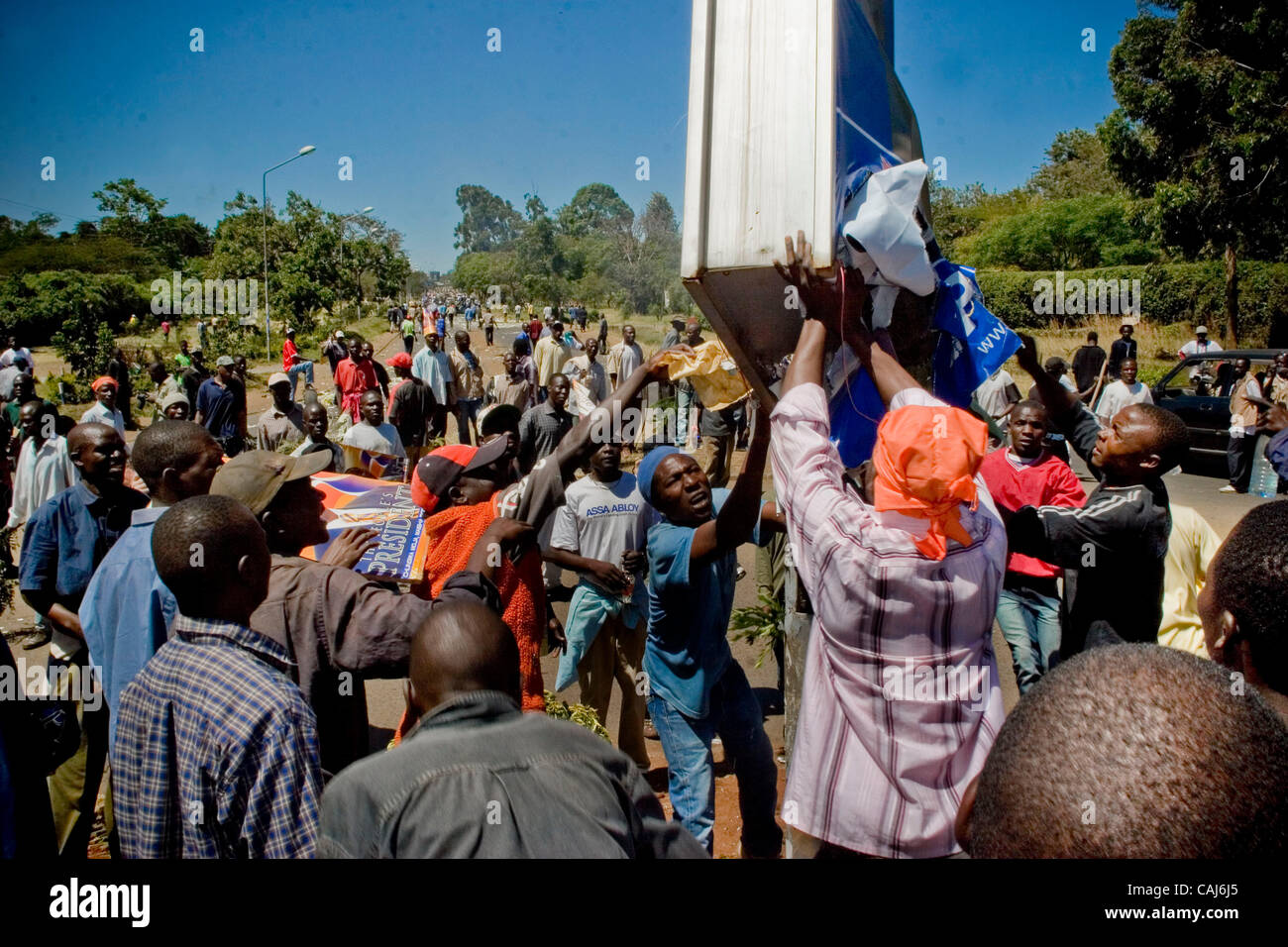 Protesters destroying a Mwai Kibaki for President poster. On new years eve violence rocked the nations capital, with demonstrators causing Havoc country – wide. With casualties topping 400, the military has been set up around the city to deter the supports of Kenyas opposition movement ODM [ The Ora Stock Photo