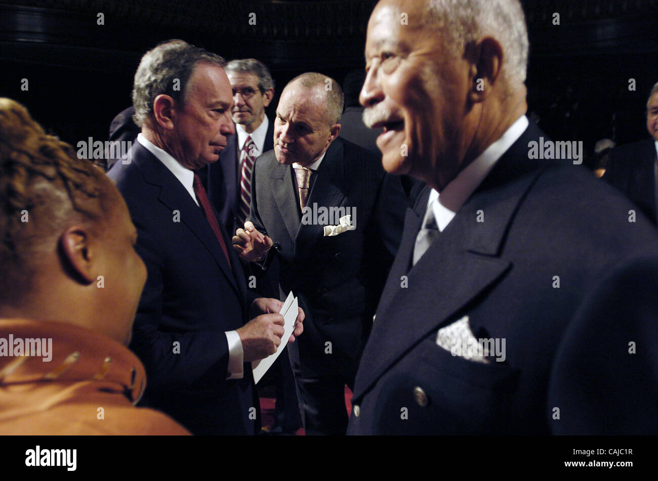 Mayor Michael Bloomberg (Center L) speaks with Police Commissioner Ray Kelly (Center R) as former Mayor David Dinkins (R) looks on. Breakfast reception to commemorate the birthday of Dr. Martin Luther King, Jr. hosted by Mayor Michael Bloomberg at City Council Chambers, City Hall. Stock Photo