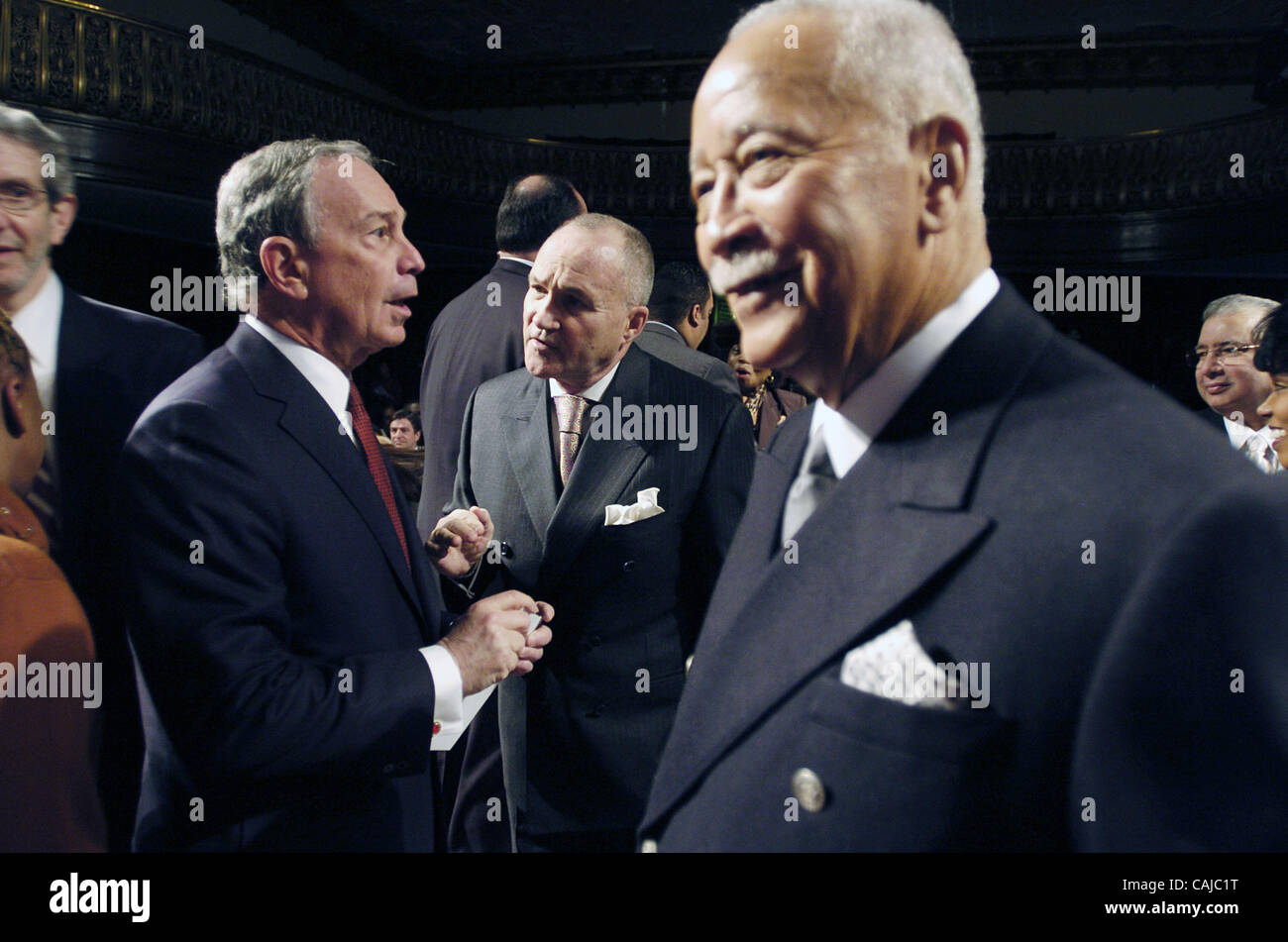 Mayor Michael Bloomberg (Center L) speaks with Police Commissioner Ray Kelly (Center R) as former Mayor David Dinkins (R) looks on. Breakfast reception to commemorate the birthday of Dr. Martin Luther King, Jr. hosted by Mayor Michael Bloomberg at City Council Chambers, City Hall. Stock Photo