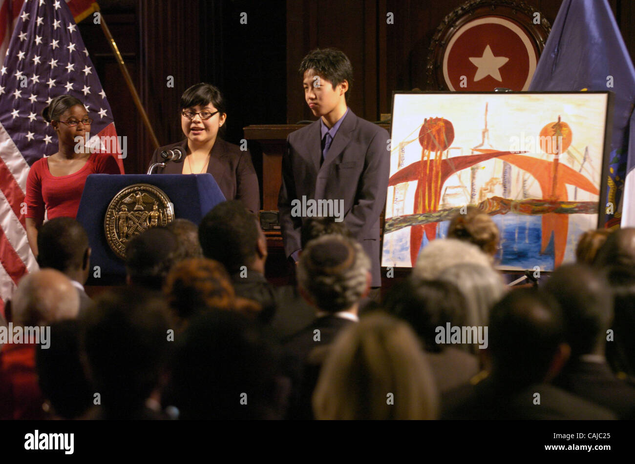 Youth Bridge-NY fellows Suewayne Burke and Kevin Li look on as Nancy Trujillo (C) describes the painting (R) she made. Breakfast reception to commemorate the birthday of Dr. Martin Luther King, Jr. hosted by Mayor Michael Bloomberg at City Council Chambers, City Hall. Stock Photo