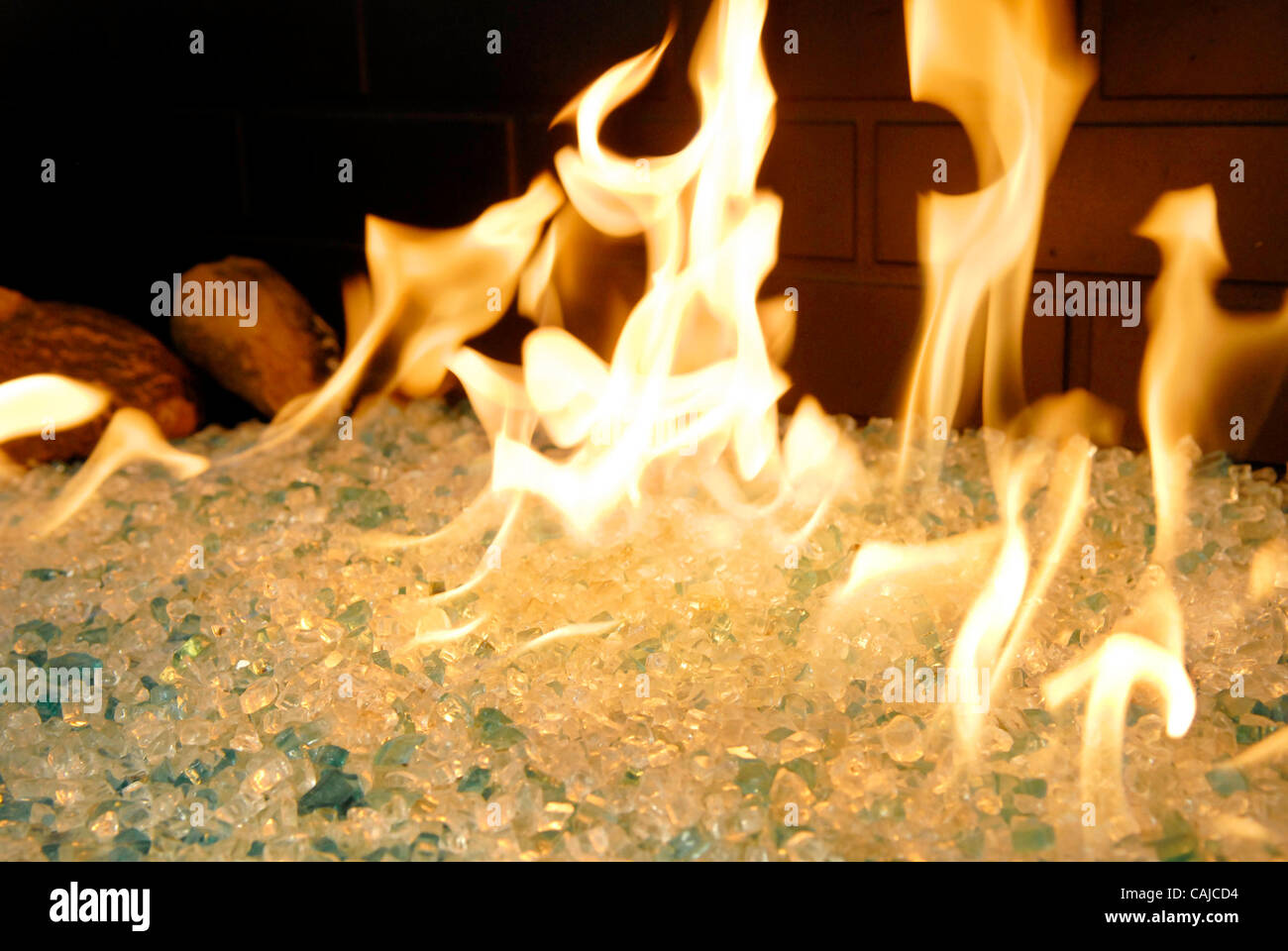 A Gas Fireplace With Glass Pieces Instead Of Imitation Logs An