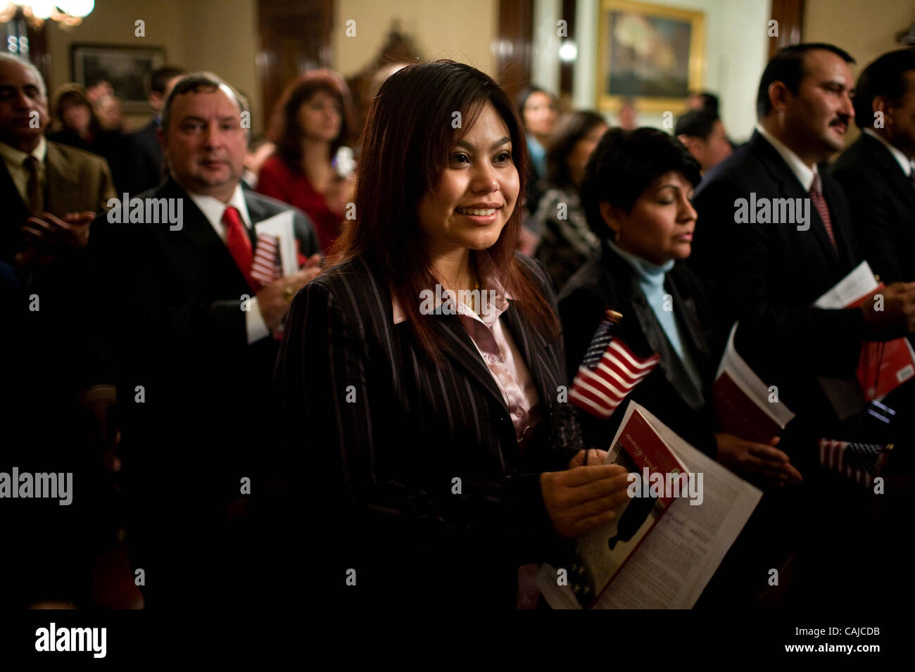 **LEDE** Jaruwan Janthorn (cq), originally from Thailand, applauds the completion of her U.S. citizenship ceremony at the Leland Stanford Mansion on Tuesday, January 21, 2008. U.S. citizenship and immigration services director Emilio Gonzalez (cq) swore in 20 new citizens. Sacramento Bee/ Kevin Germ Stock Photo