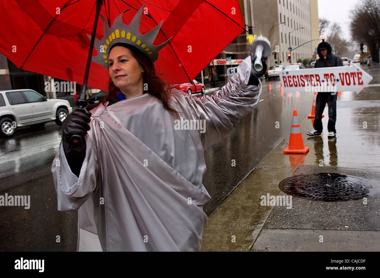 Dressed as the Statue of Liberty, Cathy Ingram-Kelly (cq) from the Elections Division of the Secretary of State's office, directs passing motorists to voter registration tables at the Sacramento Convention Center in Sacramento on Tuesday January 22, 2008. California Secretary of State Debra Bowen (c Stock Photo