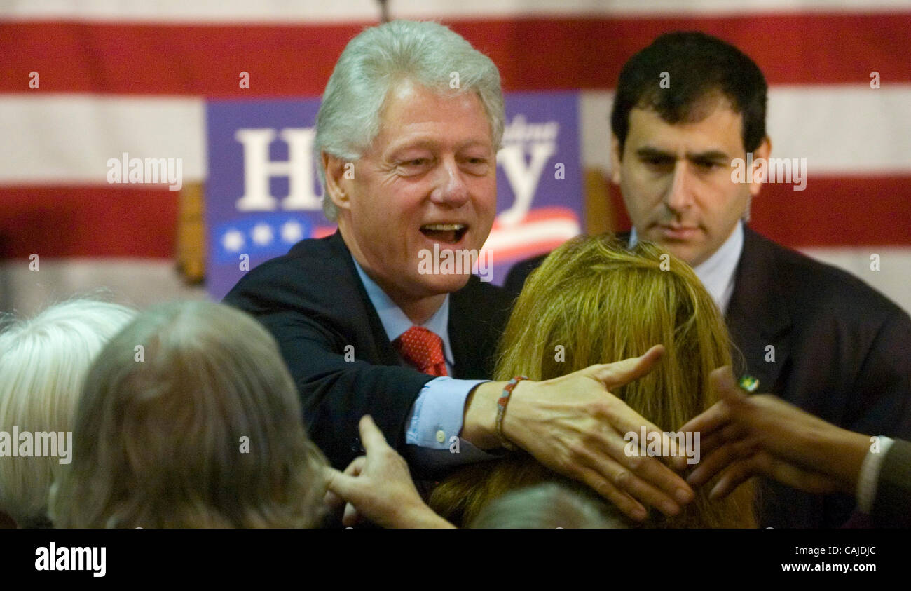 Former U.S. President Bill Clinton greets supporters during a town hall ...