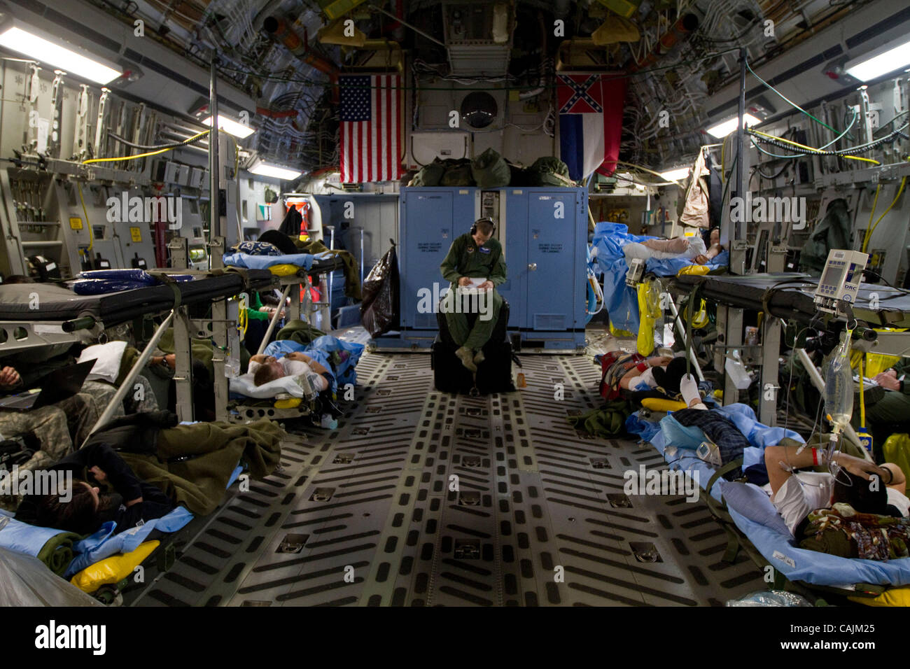 Af Senior Airman Travis Silko, a medical technician assigned to the 86th AES (Aeromedical Evacuation Squadron) based in Ramstein, Air Base, Germany, writes his report as he tends to seriously injured soldiers wounded in Afghanistan  aboard a Mississippi Air National Guard C-17 cargo plane en route   Stock Photo