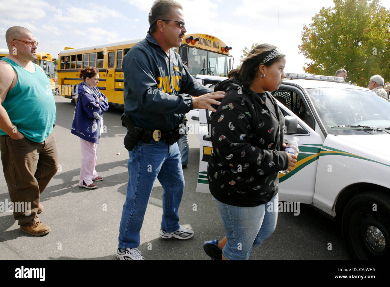 A Student leave a sheriffs car directed by Gridley Police Department Asst. Chief, Brian Cook