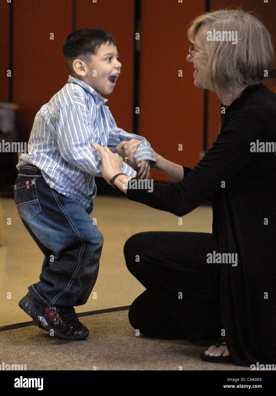 Nito Cruz, 5, moves on his feet with the assistance of Linda Bidabe (cq