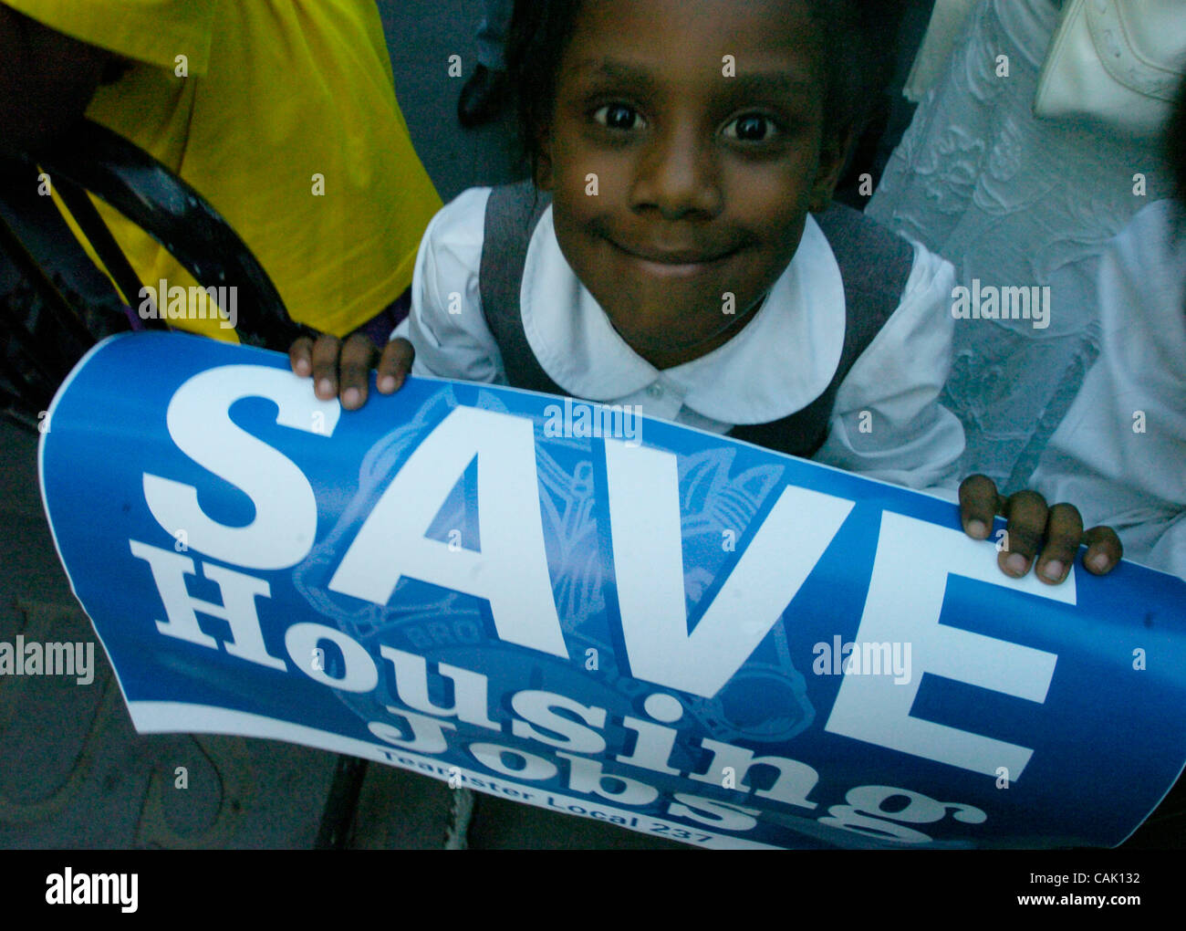 Delaine, 6, of Carver Houses holds a sign as hundreds rally in City