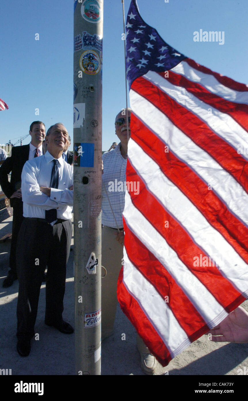 Mayor Michael Bloomberg Looks On As A Flag That Flew Over The Wtc