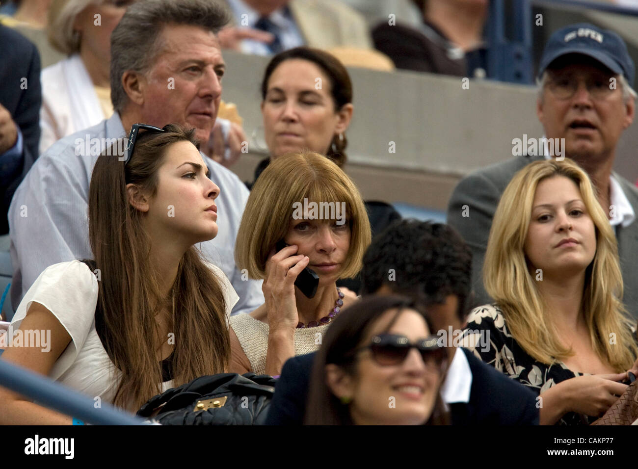 Anna Wintour talks on the phone as  Roger Federer defeats Novak Djokovic for his fourth straight title  at the 2007 US Open Tennis Championships men's final.  Dustin Hoffman and Chevy Chase are also seated in the President's Box. Stock Photo