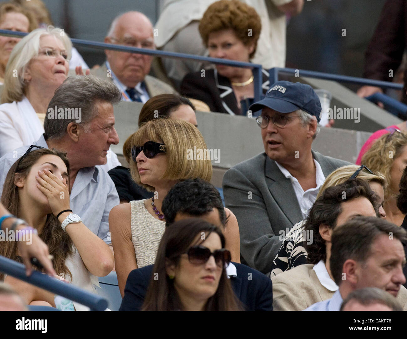 Anna Wintour watches as  Roger Federer defeats Novak Djokovic for his fourth straight title  at the 2007 US Open Tennis Championships men's final.  Dustin Hoffman and Chevy Chase are also seated in the President's Box. Stock Photo