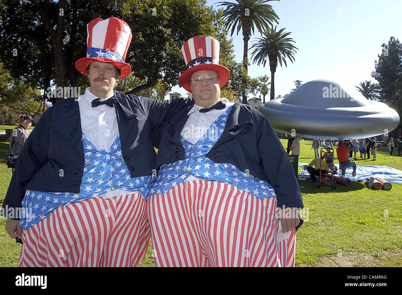 Nov. 23, 2003 - Pasadena, USA - John Ballard (right) and Fritz Ward (left) are dressed as hale and hearty Uncle Sams for the annual Dooh Dah Parade in Pasadena, California. Behind them, being filled by hot air, is a flying saucer from the Raelians, the group that last year claimed to have cloned the Stock Photo