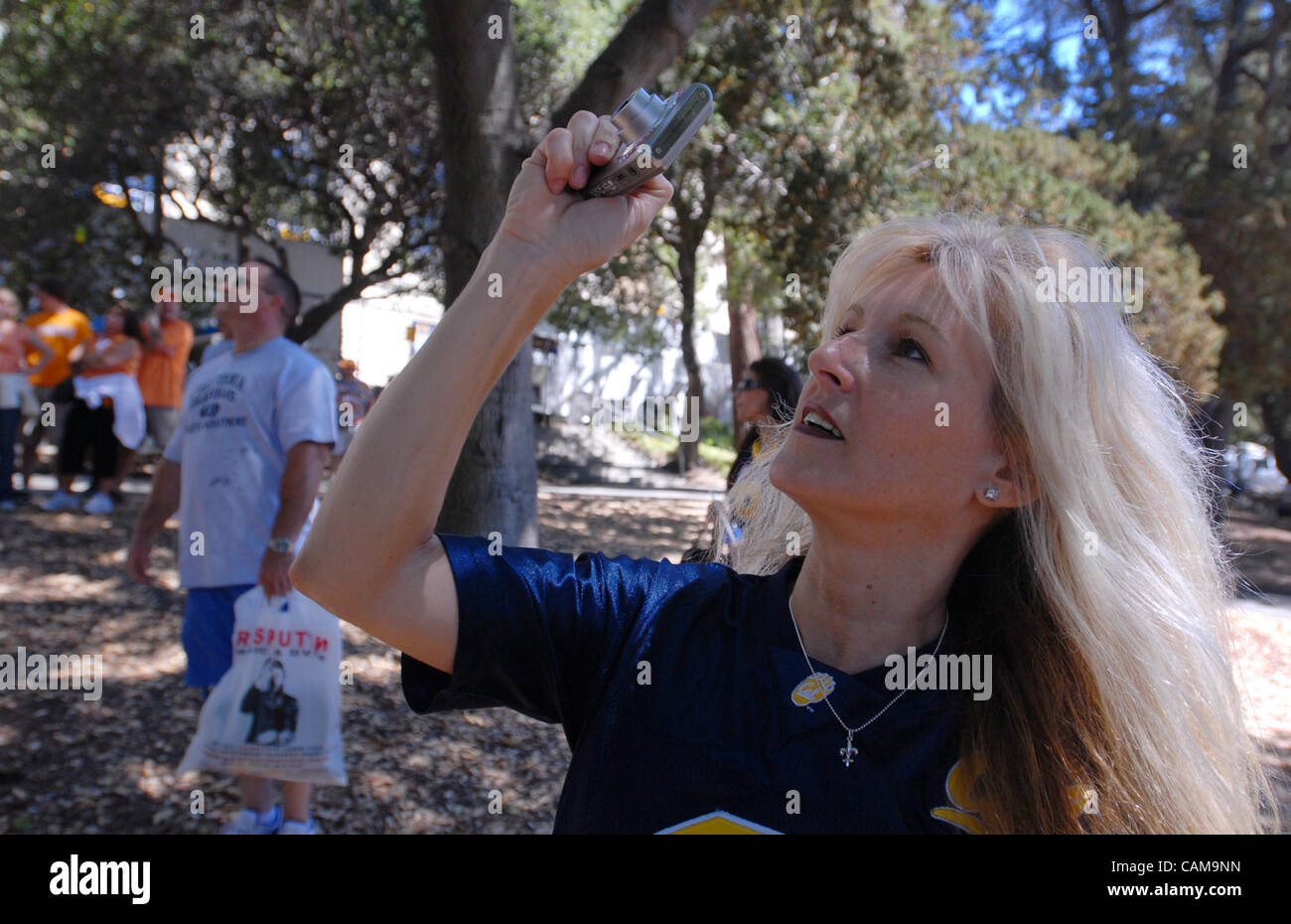 Cal fan Janice Ridondo, from Las Vegas, takes a photo of tree sitters