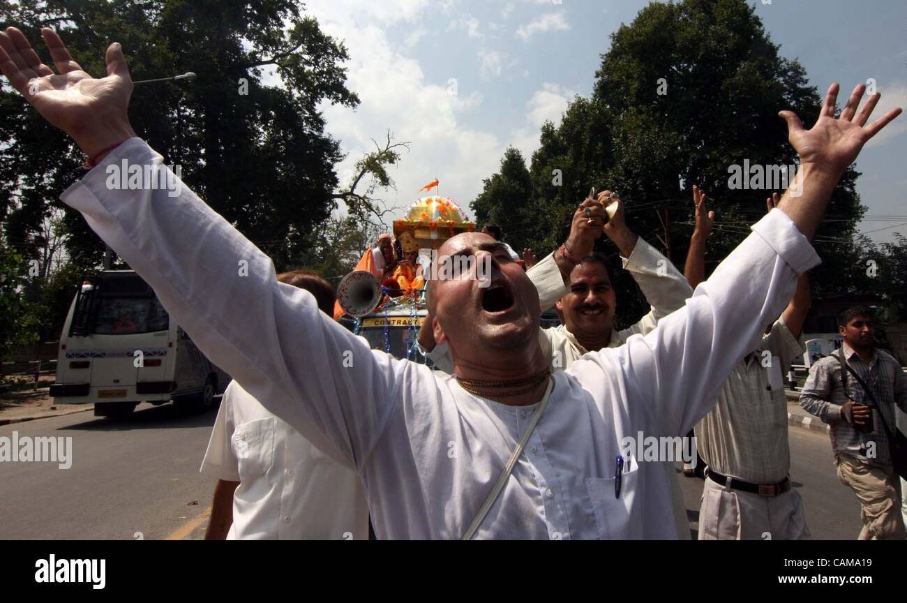 A Kashmiri pandit sings religious songs as he dances during a Shoba yatra on the occasion of 'Janmashtami' which marks the birth of Hindu God Lord Krishna, in Srinagar,the summer capital of Indian Kashmir, 03 September 2007. Janma means 'birth' and ashtami means 'eighth day'. Lord Krishna, the eight Stock Photo