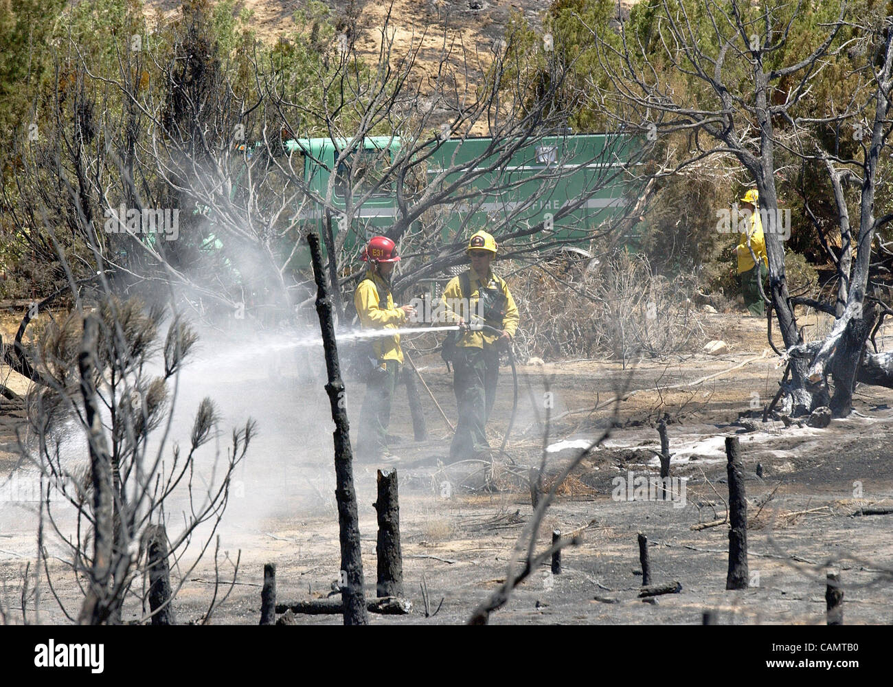 July 21, 2004 Acton, California, U.S. Firefighters hose water on