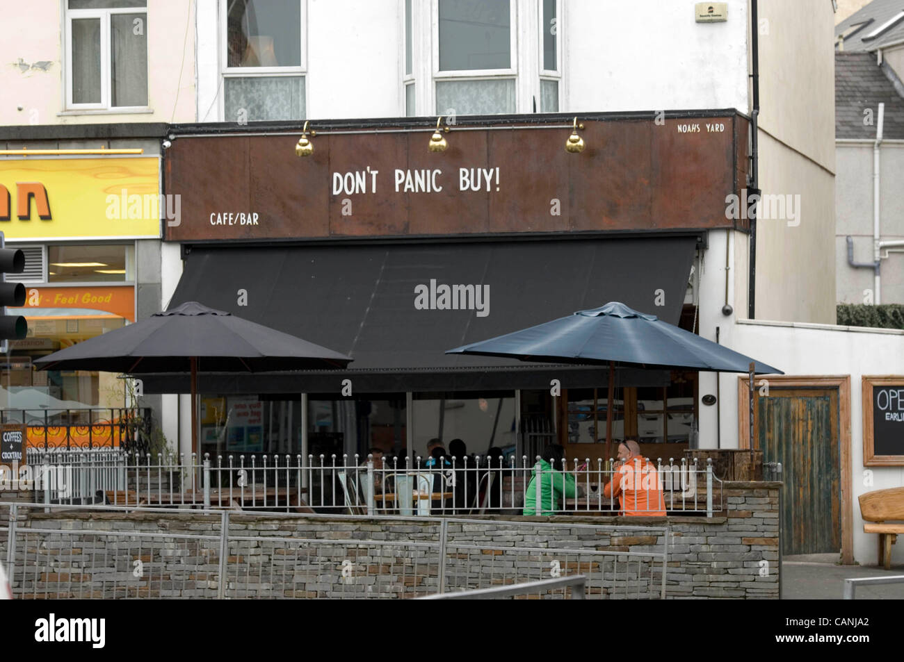 Swansea, UK. 31 Mar, 2012. Sign above Noah's Yard bar in the Uplands district of Swansea saying 'Don't Panic Buy' in reference to the fuel crisis. Stock Photo