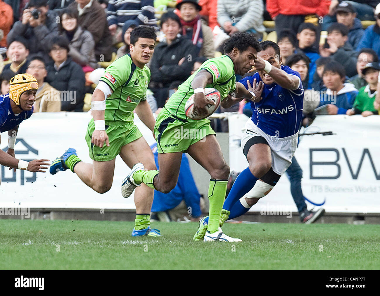 Australia's Shannon Walker brushes off a challenge from Samoa's Uale Mai to score the first fo his two tries during the cup final of  the rugby 7s world series in Tokyo, Japan on 01 April, 2012. Australia won the match 28-26.  Photographer: Robert Gilhooly Stock Photo