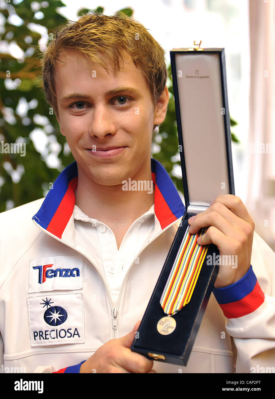 Czech figure skater Michal Brezina shows little medal for the short programme during press conference in Prague, Czech Republic on April 3, 2012 after his arrival from the Ice skating World Cup. (CTK Photo/Igor Sefr) Stock Photo