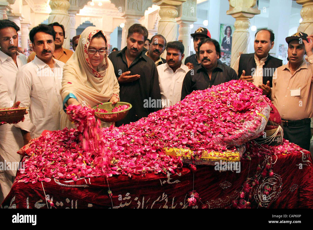 Peoples Party-SB Chairperson, Ghunwa Bhutto showers rose petals at the Grave of Peoples Party (PPP) Founder, Zulfiqar Ali Bhutto during her visits at Bhutto Mausoleum on the occasion of his Death Anniversary in Garhi Khuda Bux on Wednesday, April 04, 2012. Stock Photo