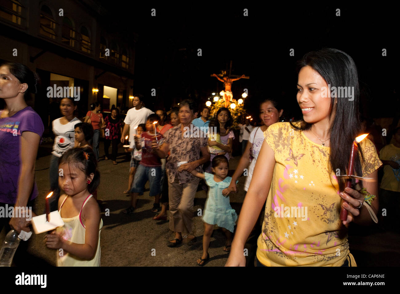 Cebu City, Philippines, 4.April 2012: Traditional Easter ceremonial parade with the Saints.  People holding candles during the parade. Stock Photo