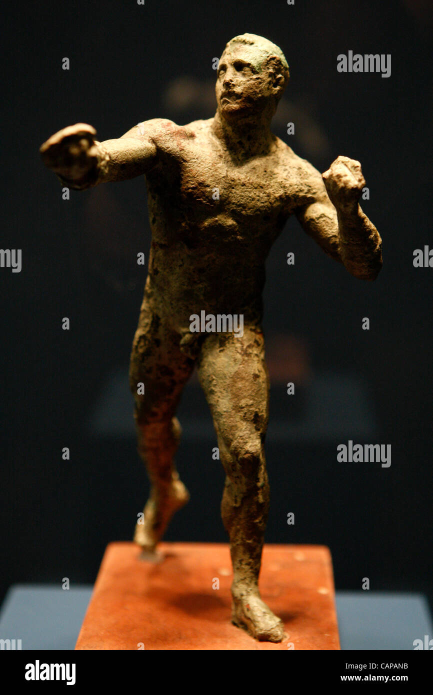 4/4/2012 Athens Greece. Bronze stattuette of a boxer, late 2nd century BC. The 'Antikythera Shipwreck' exhibition takes place at National Archaeological museum in Athens. All antiquities recovered in 1900-1901 and 1976 from the legendary shipwreck off the islet of Antikythera, South of the Peloponne Stock Photo