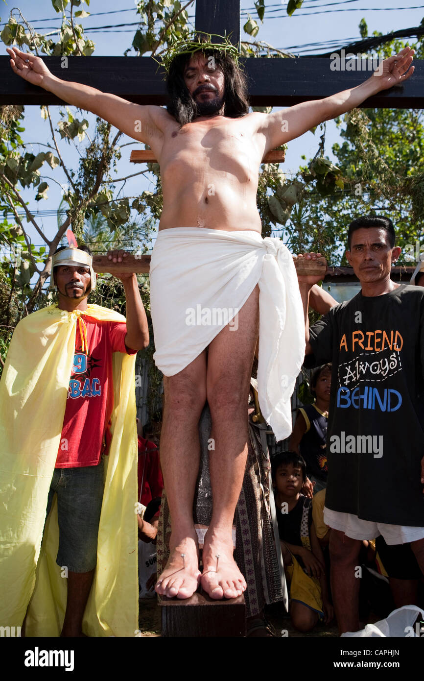 Cebu City, Philippines, Good-Friday, 6.April 2012: Gilbert Bargayo, being nailed to the cross for the 17th Good Friday. Stock Photo