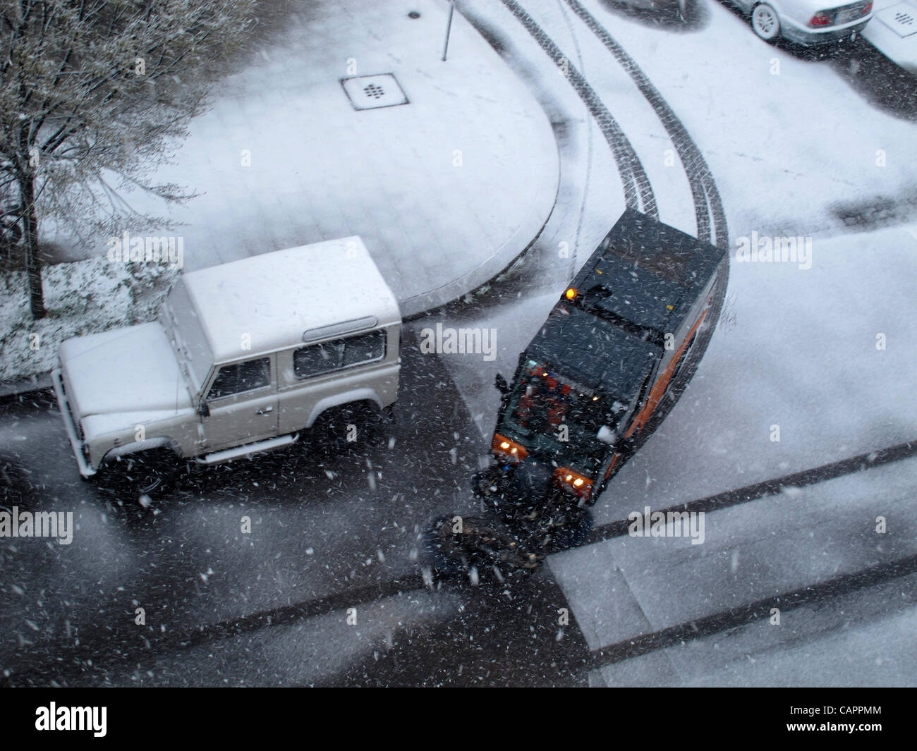 Germany Munich April 8 Easter festival light snowing. Snow in pan-Europe during the easter holiday, temperature is just over zero. A winter service car is on the way to clean snow. According to the weather report, generally pan-Europe is suffer from light snow and cloudy during the day. April snow i Stock Photo