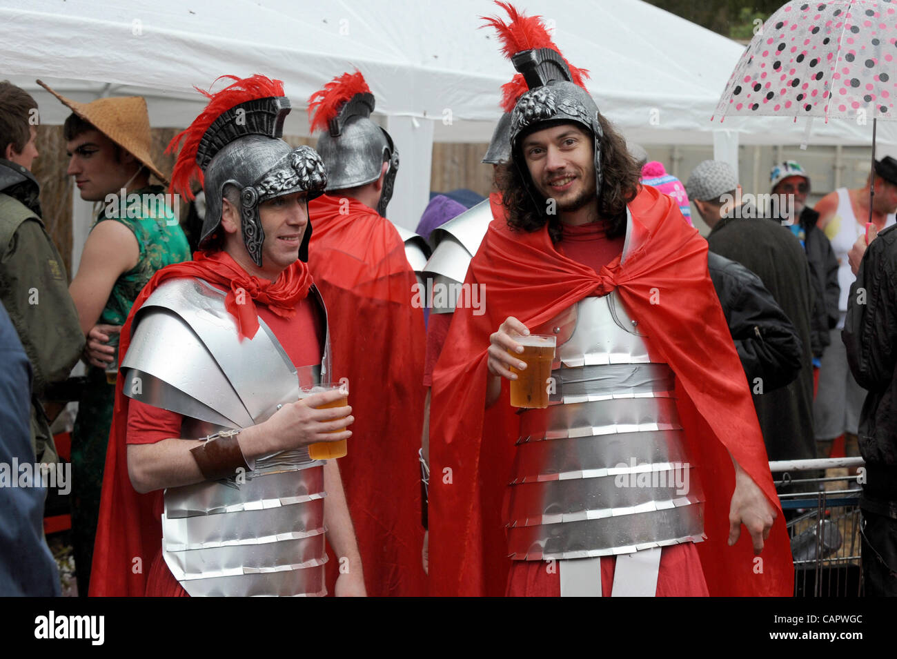 Centurians enjoy a beer despite the wind and rain before taking part in the Bolney Pram Races through the Sussex village UK Stock Photo