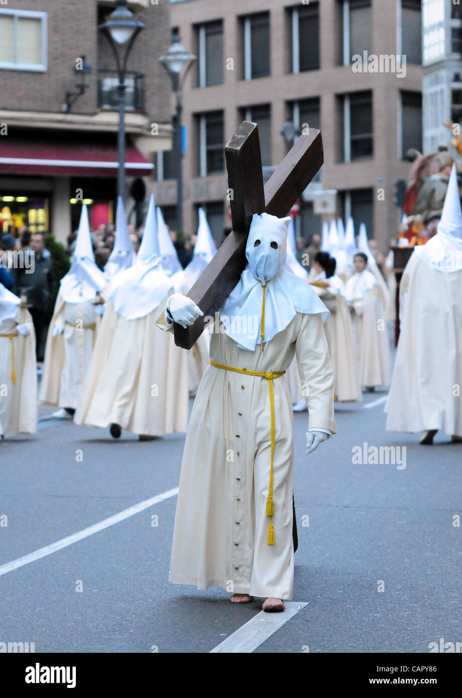 Semana Santa 2012: Traditional processions of Easter in the spanish city of Valladolid Penitent of the Cofradia de la Ultima Cena carrying a cross to emulate Jesus calvary. Stock Photo