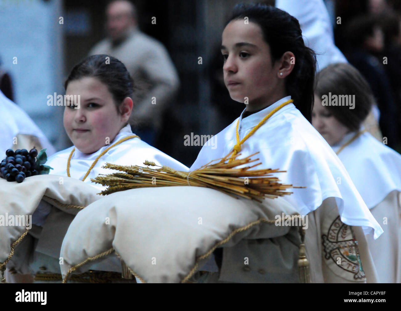 Semana Santa 2012: Traditional processions of Easter in the spanish city of Valladolid Girls of the Cofradia de la Ultima Cena carrying the symbols of the last dinner: grain and grapes representing the blood and body of Jesus following the Christian tradition. Stock Photo