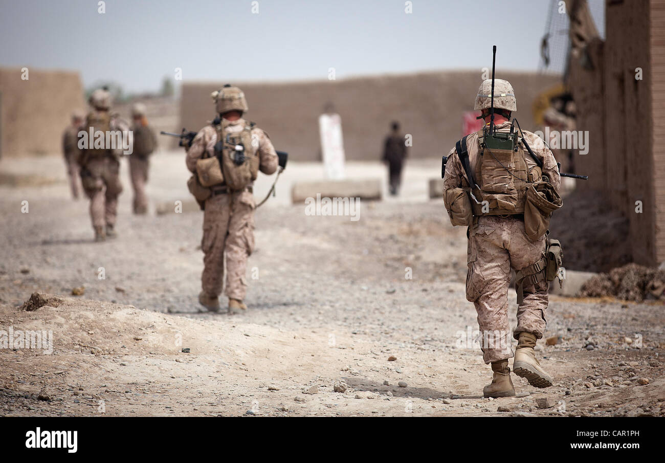 U.S. Marines with 4th Platoon, Kilo Company, 3rd Battalion, 3rd Marine Regiment, patrol past the Garmsir district center during a security patrol here, April 10, 2012. Stock Photo