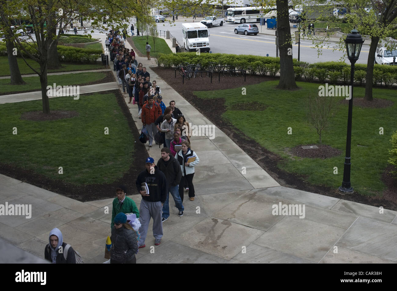 April 10, 2012 - Pittsburgh, Pennsylvania, U.S. - Students queue in a security line outside the Cathedral of Learning at the University of Pittsburgh early Tuesday morning. 57 bomb threats have been received on campus since mid-February, causing increased security measures on campus and an air of un Stock Photo