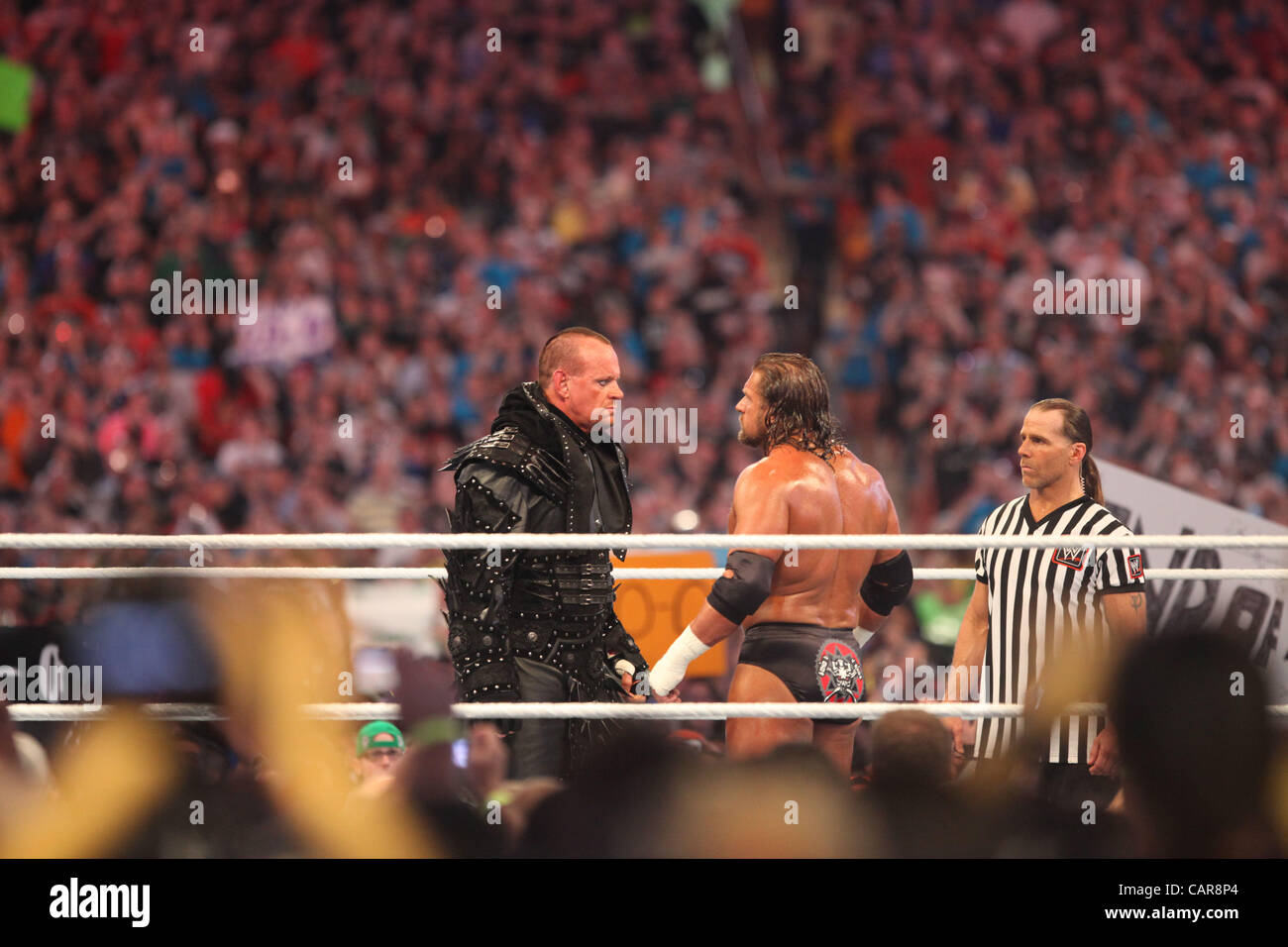 WWE legends The Undertaker wrestled Triple H at Wrestlemania 28 in Miami, FL at Sun Life Stadium. WWE Hall of Famer Shawn Michaels served as the special referee. The Undertaker won, advancing his streak to 20-0 at Wrestlemania events. Stock Photo