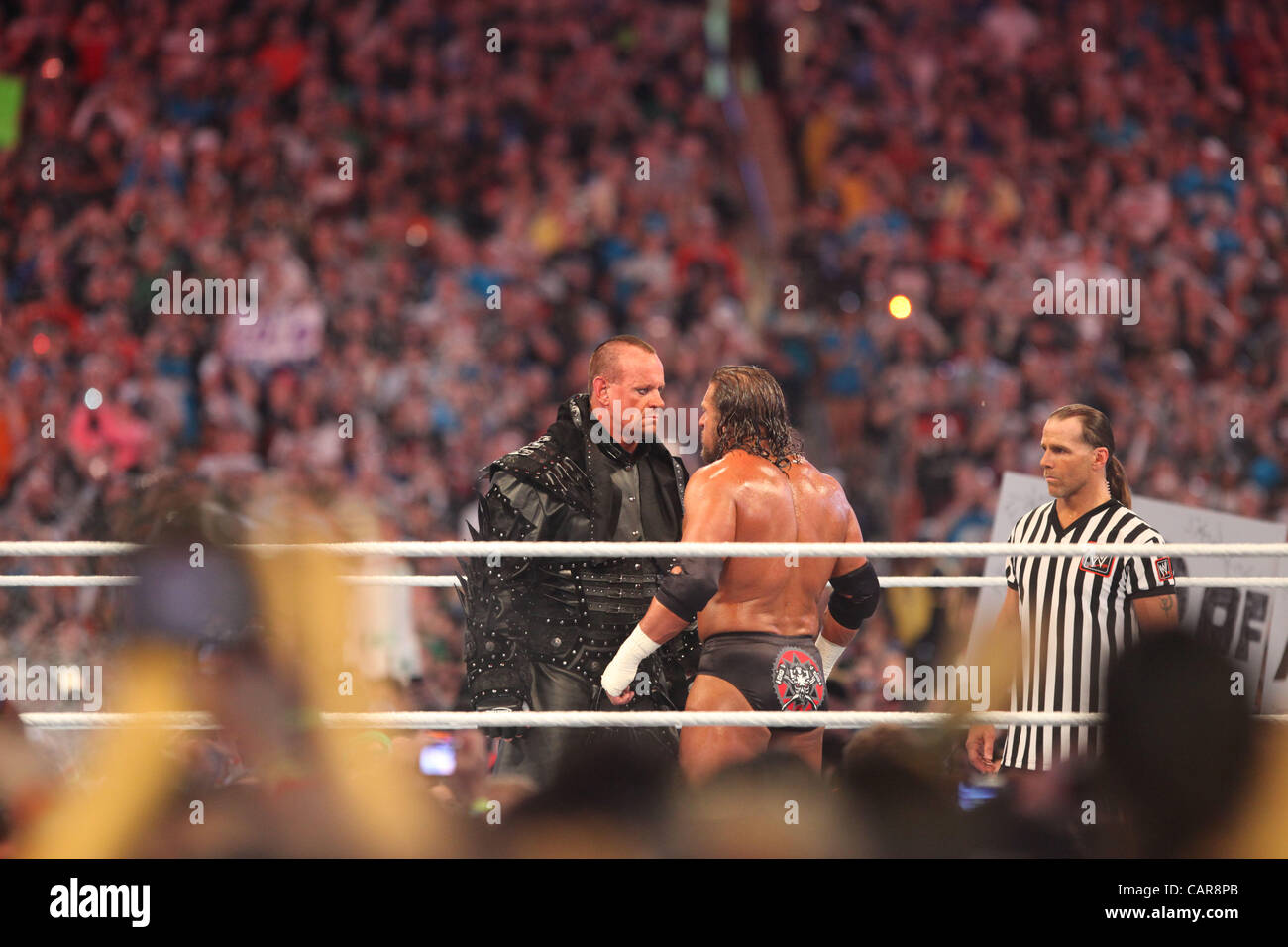 WWE legends The Undertaker wrestled Triple H at Wrestlemania 28 in Miami, FL at Sun Life Stadium. WWE Hall of Famer Shawn Michaels served as the special referee. The Undertaker won, advancing his streak to 20-0 at Wrestlemania events. Stock Photo