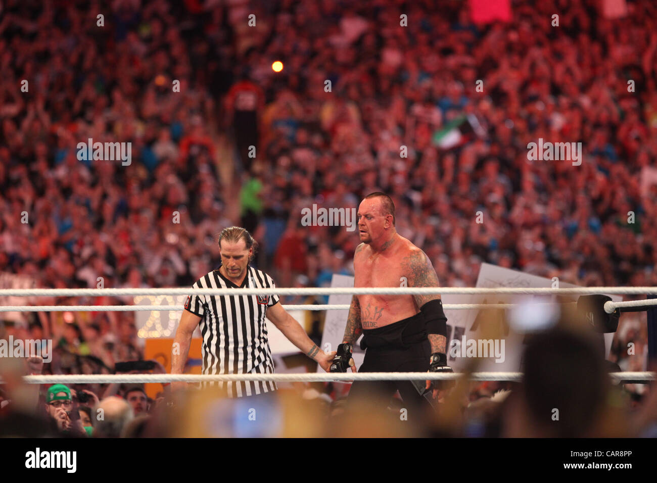 WWE legends The Undertaker wrestled Triple H at Wrestlemania 28 in Miami, FL at Sun Life Stadium. WWE Hall of Famer Shawn Michaels served as the special referee. The Undertaker won, advancing his streak to 20-0 at Wrestlemania events. Stock Photo