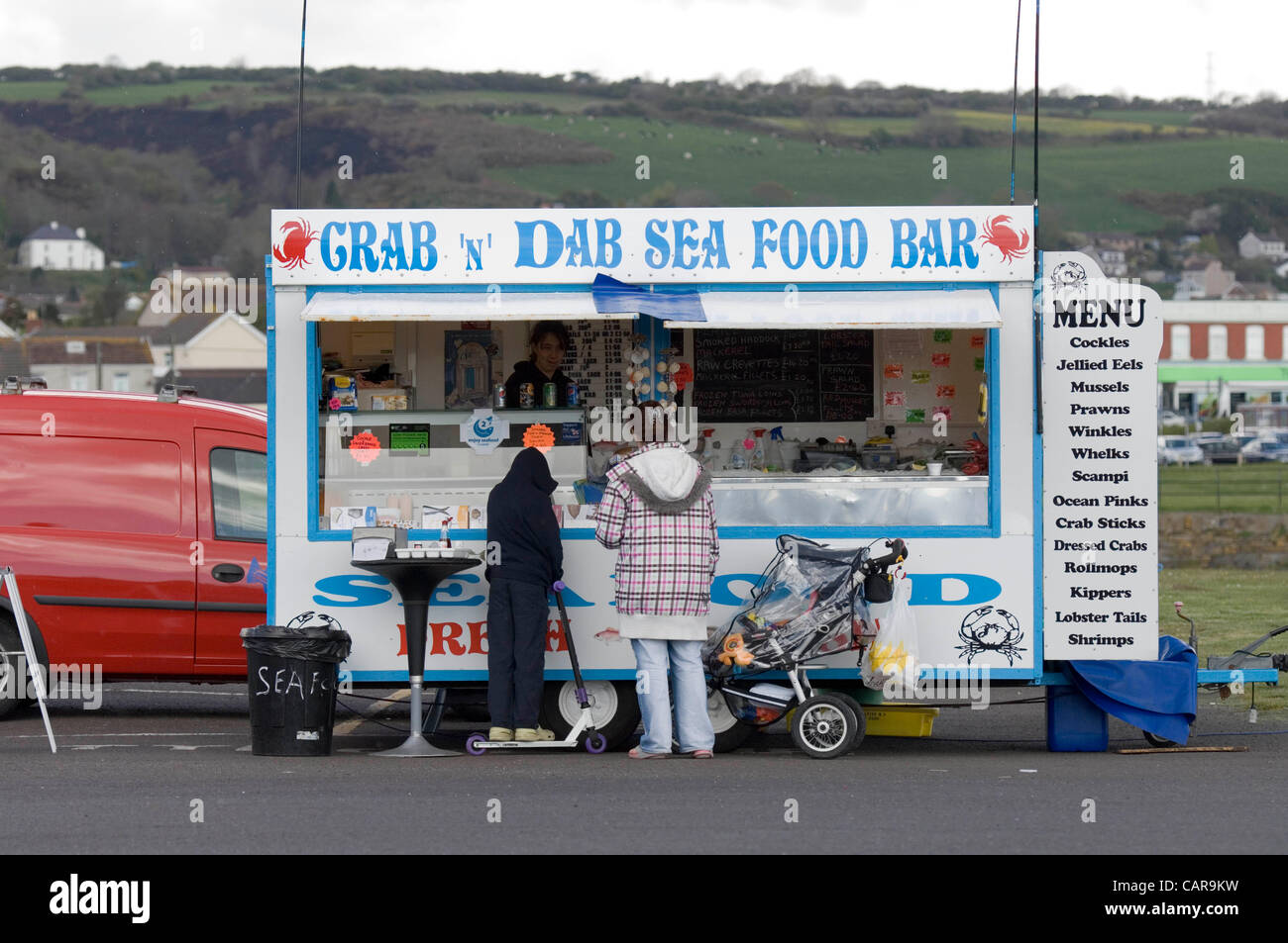 People buying seafood from a snack bar on the harbourside in Burry Port