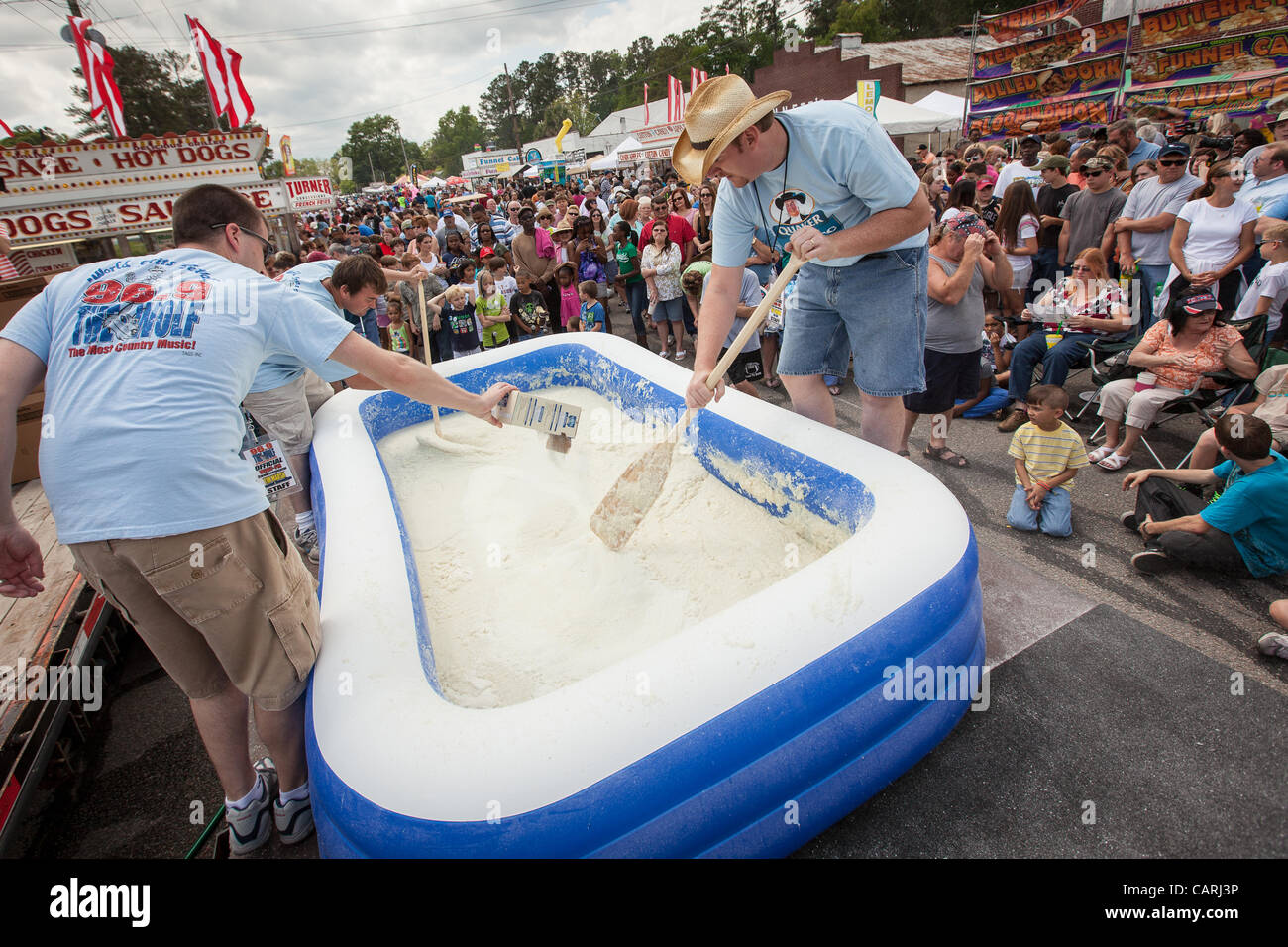 Workers prepare a pool of instant grits at the World Grits Festival
