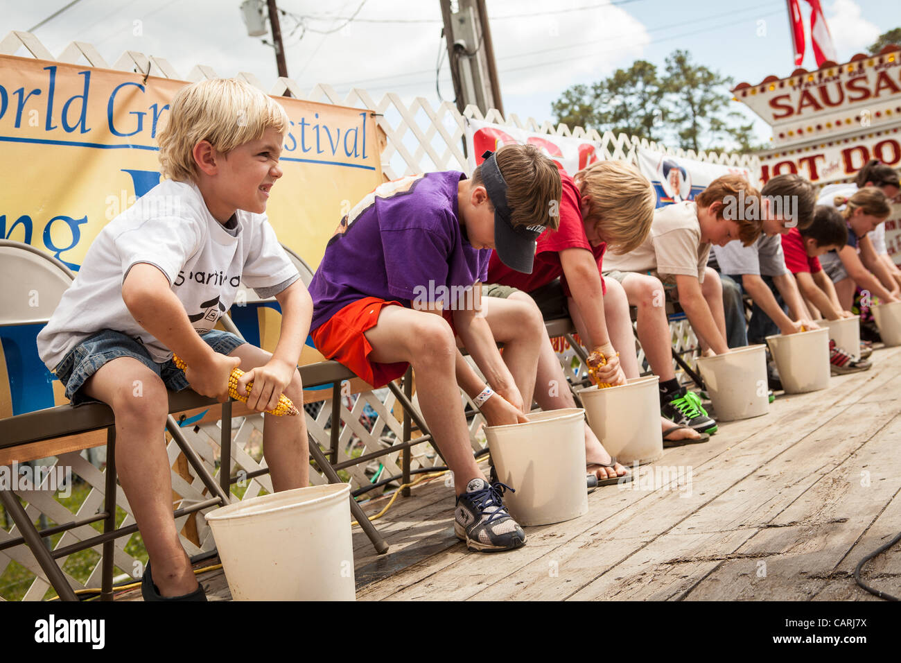 Young competitors race to husk the most corn at the World Grits Festival April 14, 2012 in St. George, SC. The festival celebrates the southern love for the sticky corn porridge Stock Photo