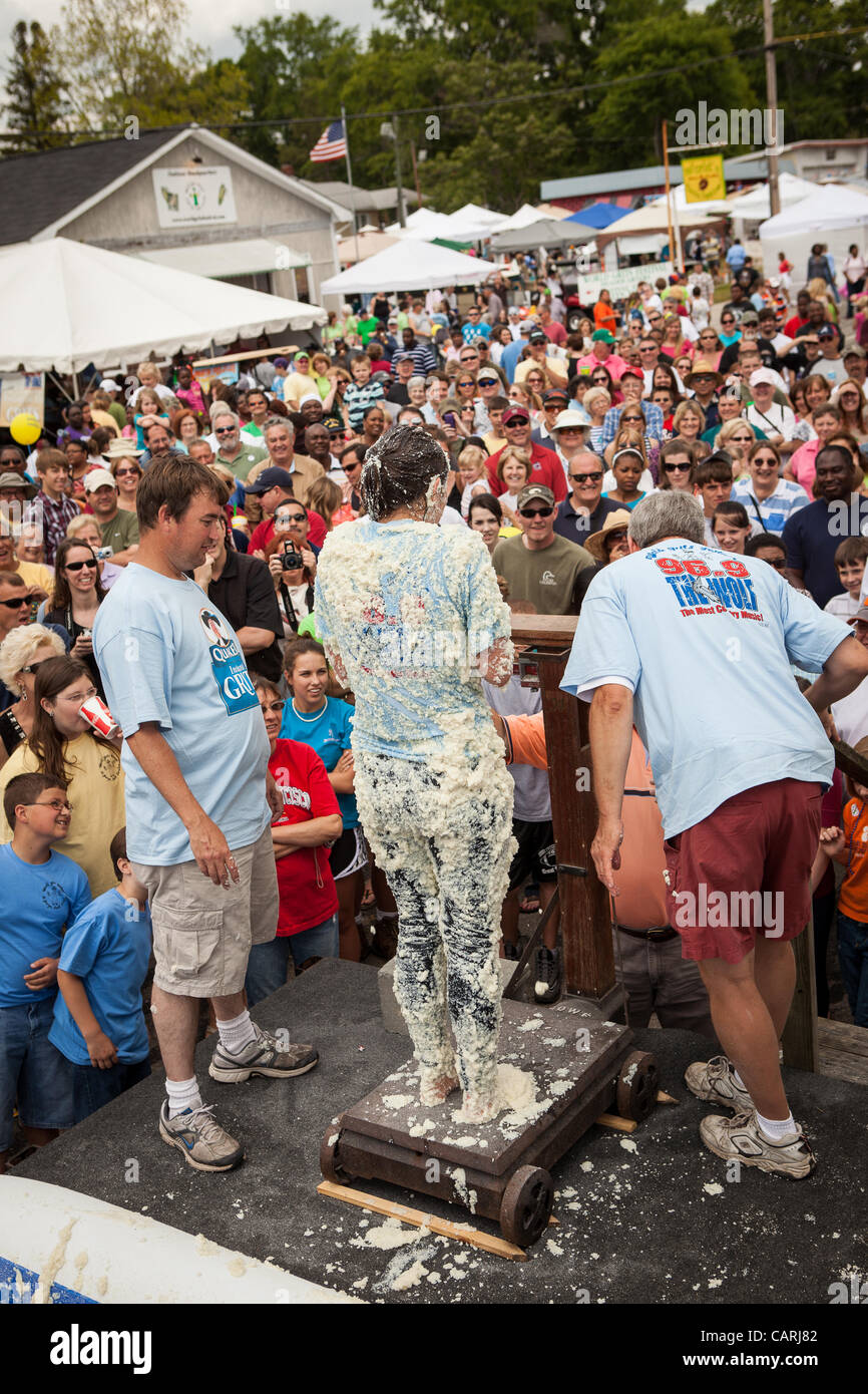 A competitor is weighted covered in grits after rolling around in a