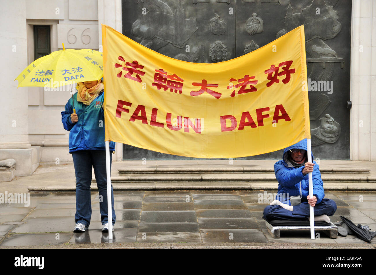 April 15th, 2012. Falun Dafa protesters hold a banner outside the Chinese Embassy in London. A spiritual discipline in China from 1992, the practice is now banned in China, members claim human rights abuse by the Chinese government. Stock Photo