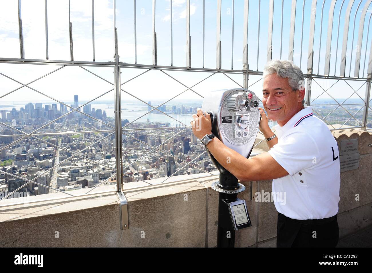April 17, 2012 - Manhattan, New York, U.S. - GREG LOUGANIS, four-time gold medal winning diver (Los Angeles 1984, Seoul 1988) lights the Empire State Building red/white/blue to mark 100 days to the start of the London 2012 Olympic Games. (Credit Image: © Bryan Smith/ZUMAPRESS.com) Stock Photo
