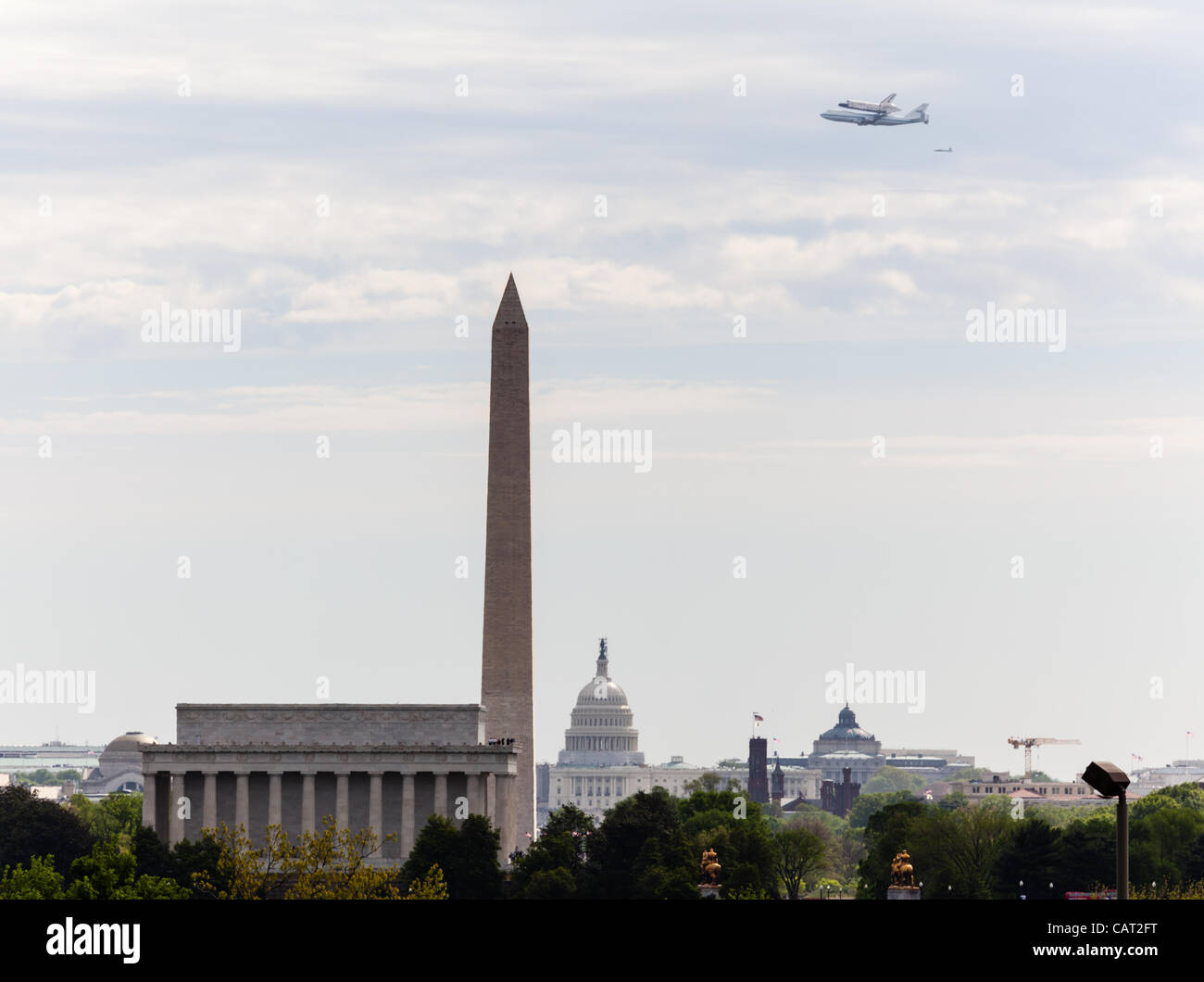 WASHINGTON DC - APRIL 17: Space Shuttle Discovery flies over Washington DC on April 17, 2012 on route to its final resting place in the Air and Space Museum Stock Photo