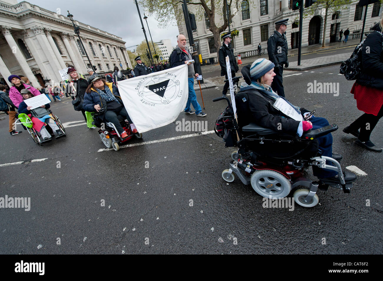Members of DPAC (Disabled people against cuts) and UKUncut march from Leicester Square to Trafalgar Square where they block the junction with the Strand. They are protesting about the cuts to Remploy Factories and the Welfare Reform Bill in general. London UK, 18 April 2012. Stock Photo