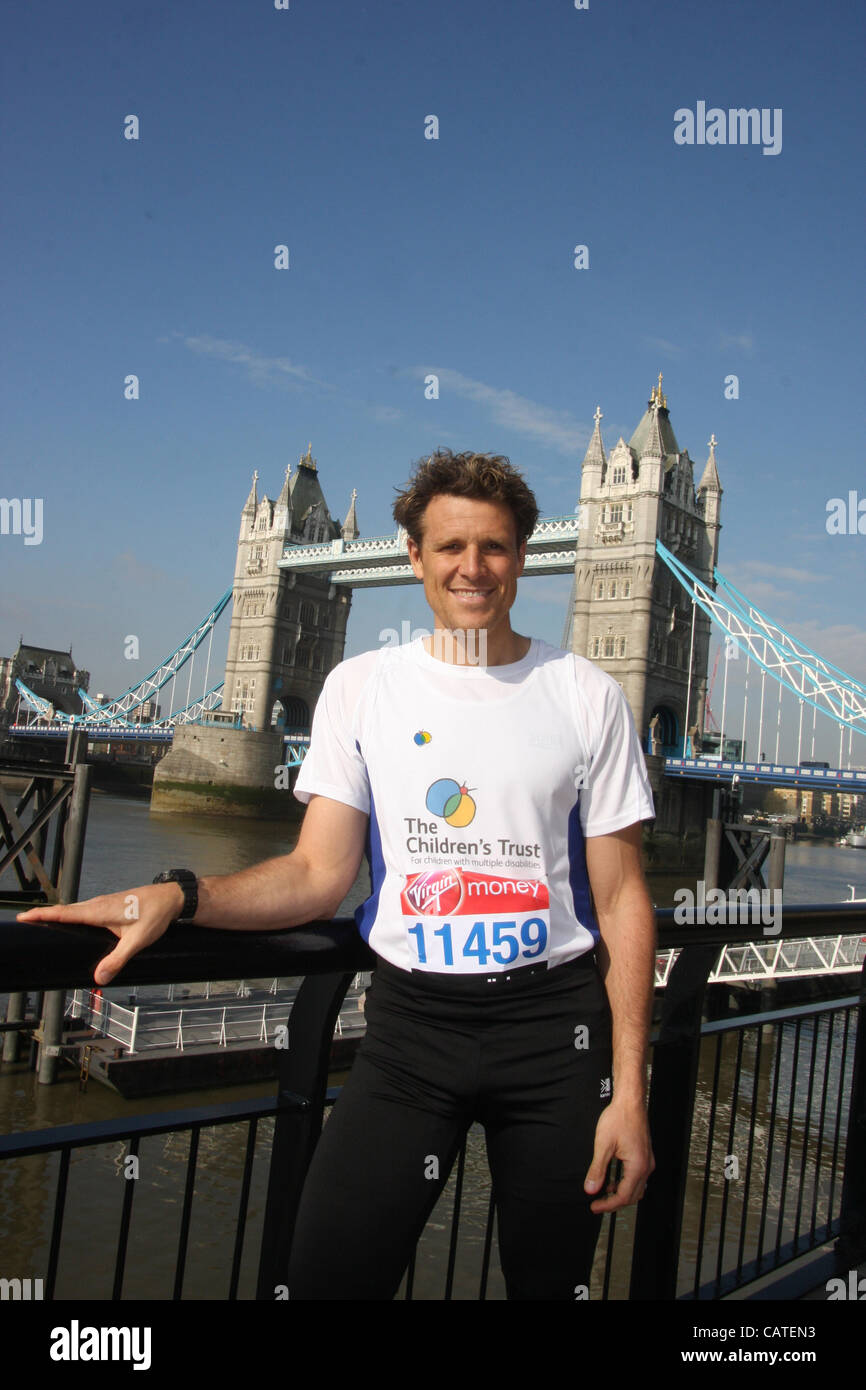 Friday 20th April 2012, London UK. British rowing champion and double Olympic gold medalist James cracknell in front of Tower Bridge at the photocall for Celebrity runners at the 2012 Virgin London Marathon. Stock Photo