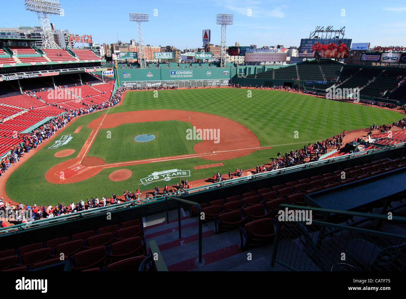 Boston, Massachusetts, USA. April 19, 2012. One Hour after Fenway Park opened to the public for an open house on its 100th Anniversary. Red Sox fans lined up along the edge of the stadium in order to catch a glimpse of the dugouts, Green Monster and bullpens. Stock Photo