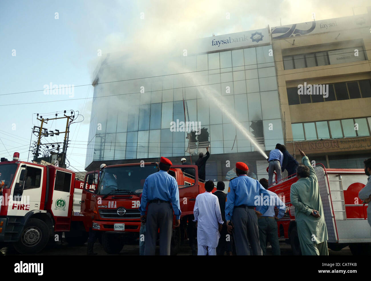 Firefighters Extinguish Fire On A Burning Portion Of Faysal Bank